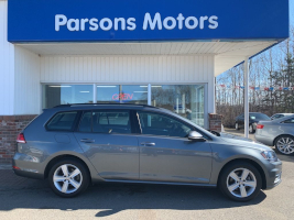 Light blue 2019 Volkswagen® Golf Sportwagon car on a parking lot in front of Parsons Motors.